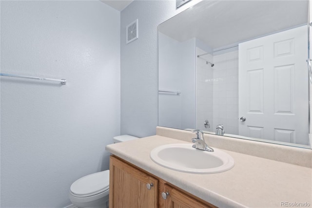 12711 Colorado Blvd Unit 1116, Thornton, CO 80241 - full bathroom featuring a textured wall, vanity, toilet, and a shower
