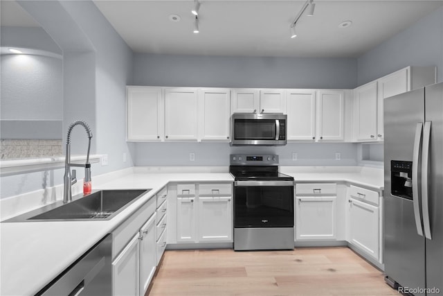 12711 Colorado Blvd Unit 1116, Thornton, CO 80241 - kitchen featuring stainless steel appliances, a sink, white cabinetry, and light wood-type flooring
