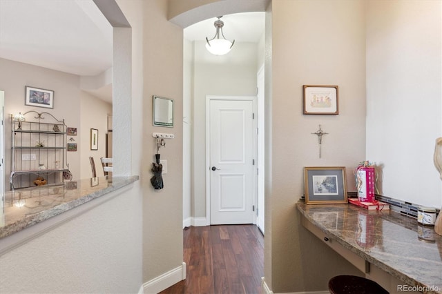 corridor featuring dark hardwood / wood-style floors