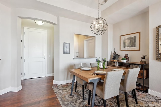 dining room featuring dark wood-type flooring and a chandelier