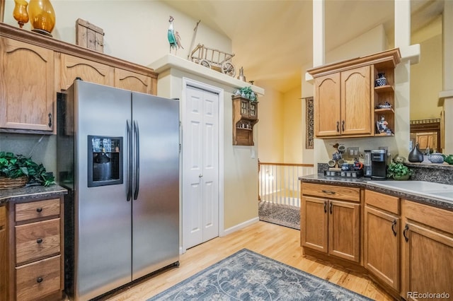 kitchen featuring light hardwood / wood-style floors, sink, lofted ceiling, and stainless steel refrigerator with ice dispenser