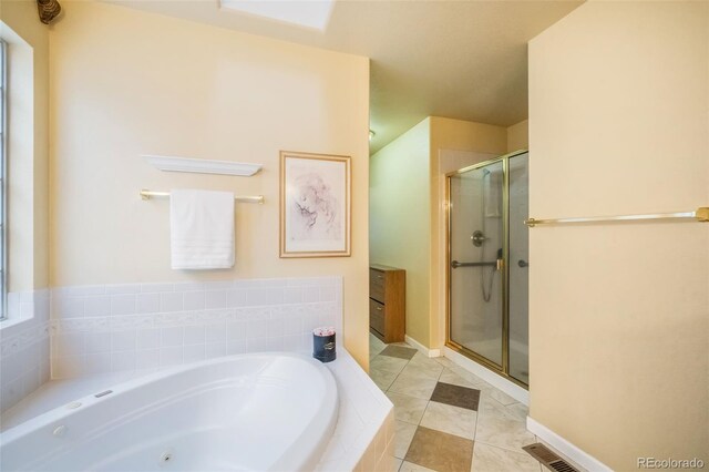 bathroom featuring tile patterned floors and independent shower and bath