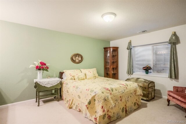 bedroom with light colored carpet