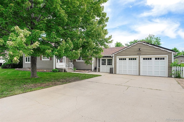 8525 Grandview Ave, Arvada, CO 80002 - view of front facade with driveway, a front yard, and a garage