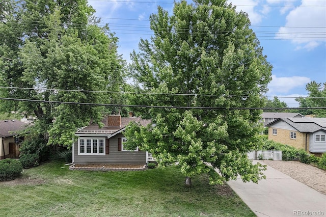8525 Grandview Ave, Arvada, CO 80002 - view of front of house with concrete driveway and a chimney