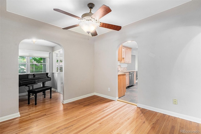 8525 Grandview Ave, Arvada, CO 80002 - unfurnished room with arched walkways, light wood-type flooring, and a ceiling fan