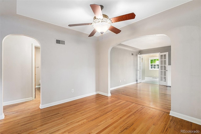 8525 Grandview Ave, Arvada, CO 80002 - unfurnished room with arched walkways, a ceiling fan, and light wood-style flooring