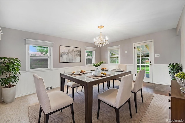 8525 Grandview Ave, Arvada, CO 80002 - dining space featuring a wainscoted wall, a chandelier, and wood finished floors