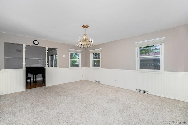 8525 Grandview Ave, Arvada, CO 80002 - carpeted empty room with a chandelier and a wainscoted wall