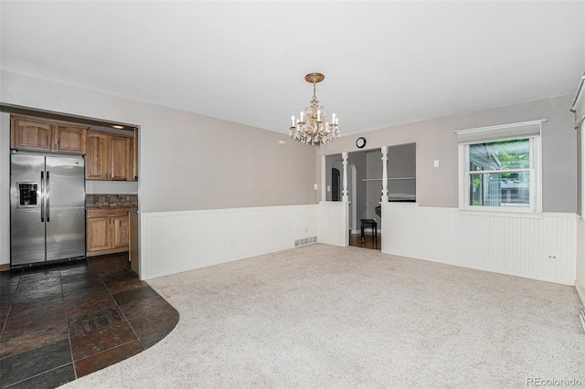 8525 Grandview Ave, Arvada, CO 80002 - unfurnished dining area featuring a chandelier and a wainscoted wall