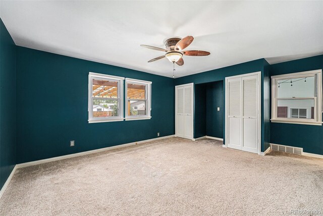 8525 Grandview Ave, Arvada, CO 80002 - unfurnished bedroom with two closets, carpet floors, and a ceiling fan