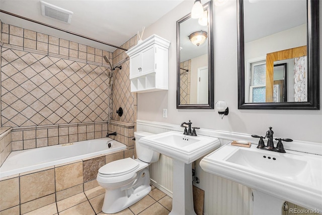 8525 Grandview Ave, Arvada, CO 80002 - full bathroom featuring tile patterned flooring, tiled shower / bath combo, and a wainscoted wall
