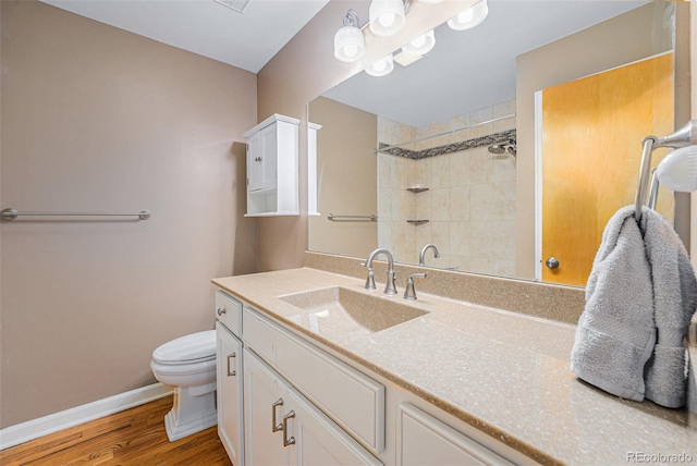 8525 Grandview Ave, Arvada, CO 80002 - full bath featuring vanity, a tile shower, and wood finished floors