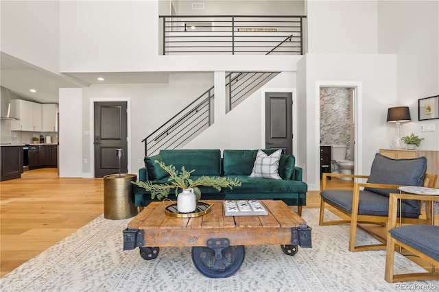 518 Conifer Dr, Bailey, CO 80421 - living area featuring a high ceiling, light wood finished floors, and stairs