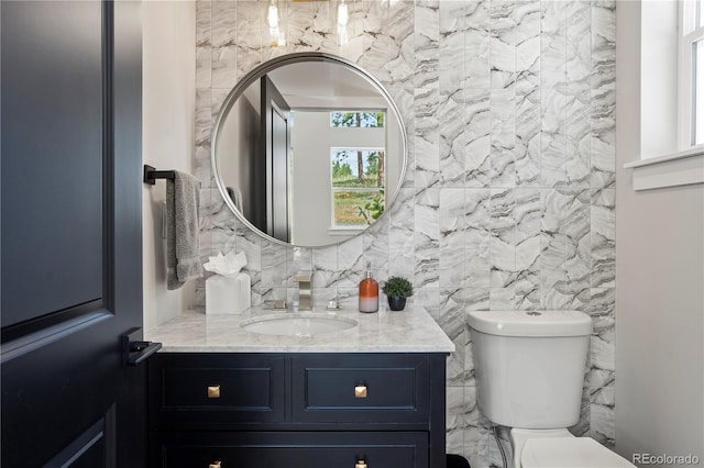 518 Conifer Dr, Bailey, CO 80421 - bathroom featuring vanity, decorative backsplash, and tile walls