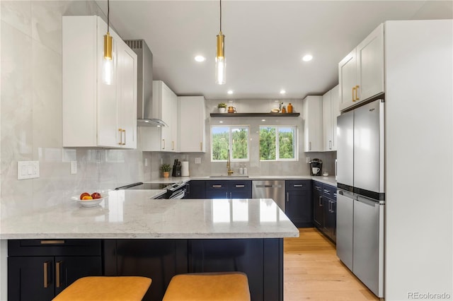 518 Conifer Dr, Bailey, CO 80421 - kitchen with appliances with stainless steel finishes, wall chimney range hood, a peninsula, light stone counters, and recessed lighting