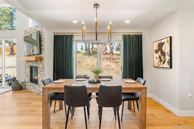 518 Conifer Dr, Bailey, CO 80421 - dining space with a chandelier, light wood-type flooring, a fireplace, and recessed lighting