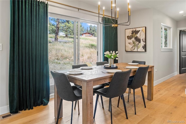 518 Conifer Dr, Bailey, CO 80421 - dining space featuring a chandelier, light wood-style floors, healthy amount of natural light, and recessed lighting