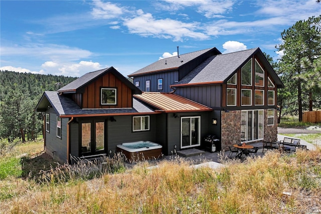 518 Conifer Dr, Bailey, CO 80421 - rear view of house featuring board and batten siding, roof with shingles, and stone siding