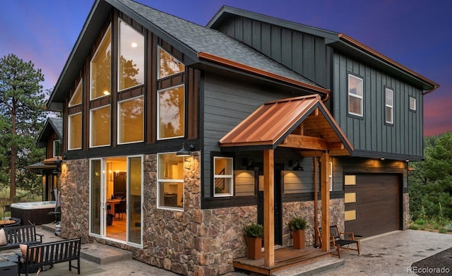 518 Conifer Dr, Bailey, CO 80421 - view of front of house with stone siding, board and batten siding, an attached garage, and asphalt driveway