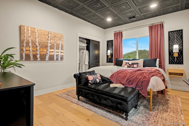 518 Conifer Dr, Bailey, CO 80421 - bedroom with wood finished floors, an ornate ceiling, recessed lighting, and a closet