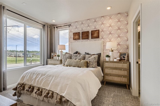 bedroom with carpet and multiple windows