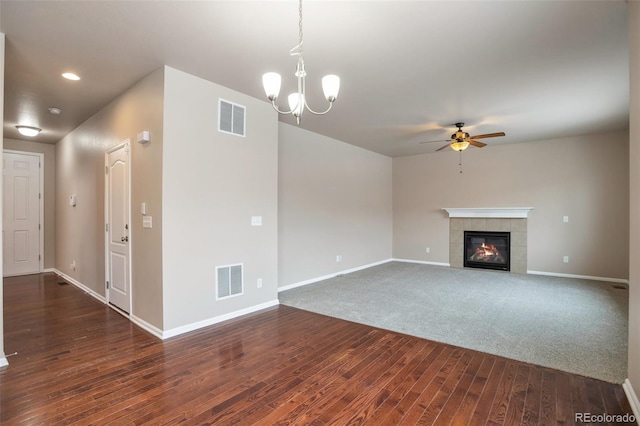 unfurnished living room featuring a fireplace, visible vents, dark wood finished floors, and baseboards