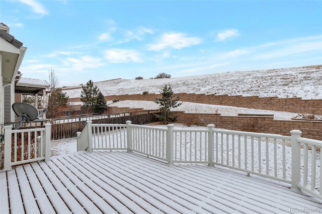 snow covered deck with fence