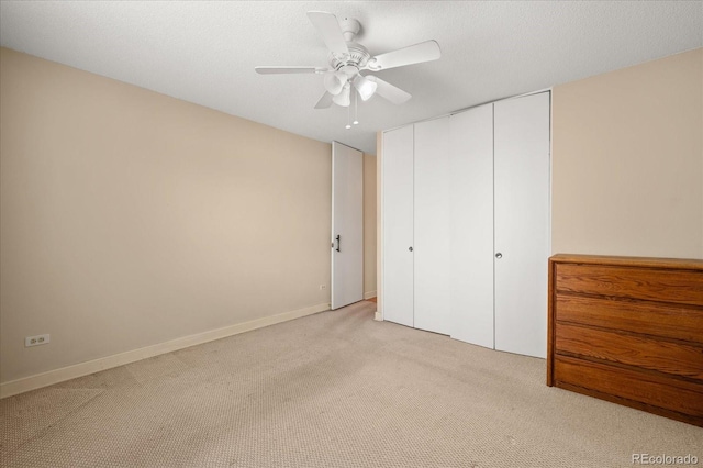 720 S Clinton St Unit 1B, Denver, CO 80247 - unfurnished bedroom with light carpet, a closet, ceiling fan, and baseboards