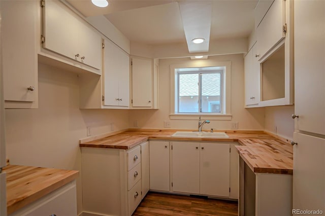 327 E 7th St, Walsenburg, CO 81089 - kitchen featuring wood counters, a sink, dark wood finished floors, and white cabinetry