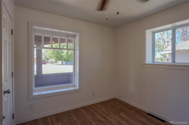 327 E 7th St, Walsenburg, CO 81089 - empty room featuring healthy amount of natural light, dark wood-type flooring, and baseboards