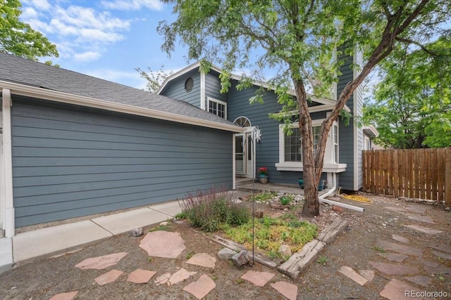 13341 Birch Cir, Thornton, CO 80241 - view of home's exterior featuring a patio area and roof with shingles