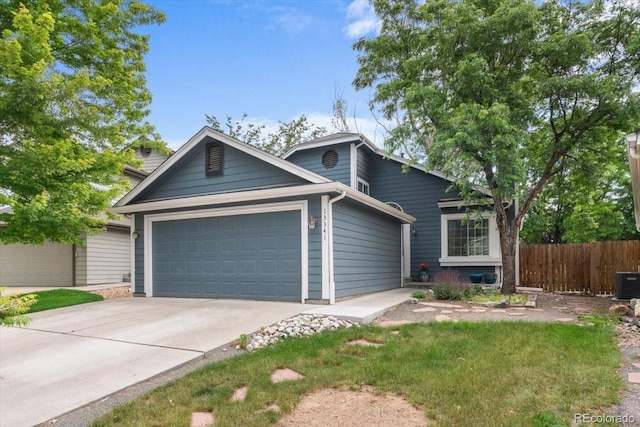 13341 Birch Cir, Thornton, CO 80241 - view of front of home featuring a garage and concrete driveway