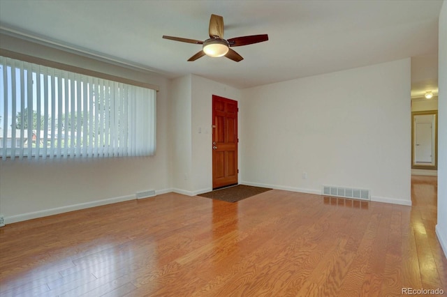 unfurnished room with wood-type flooring and ceiling fan