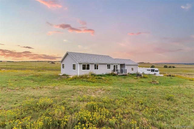 single story home featuring a yard