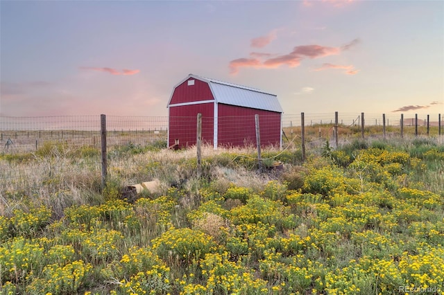 view of barn featuring fence