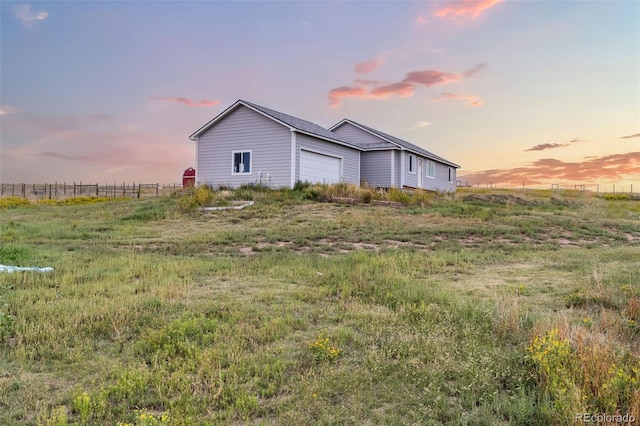 view of home's exterior featuring fence and an attached garage