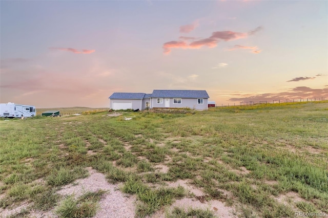 22685 Cow Cir, Ramah, CO 80832 - yard at dusk with an attached garage and a rural view