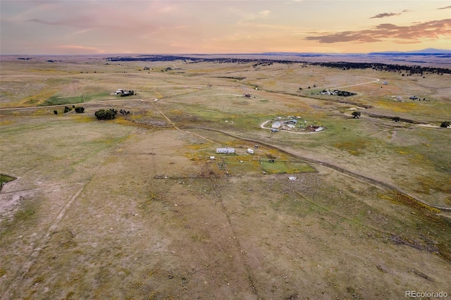 aerial view at dusk featuring a rural view