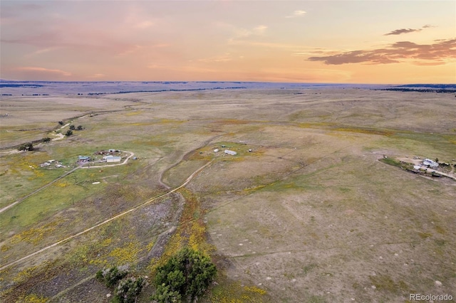 aerial view at dusk featuring a rural view