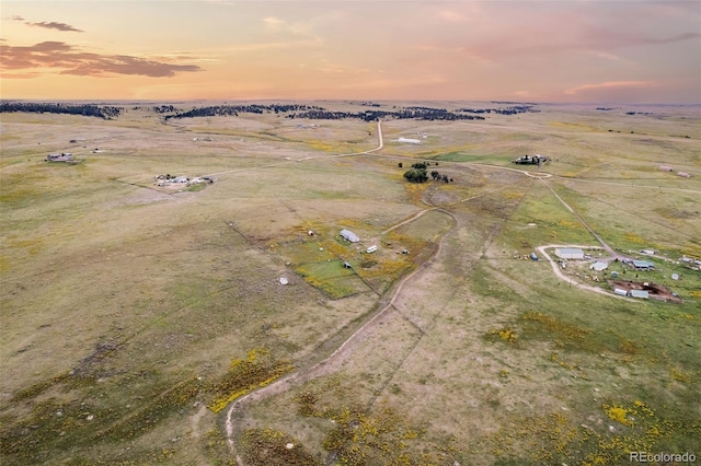 aerial view at dusk featuring a rural view