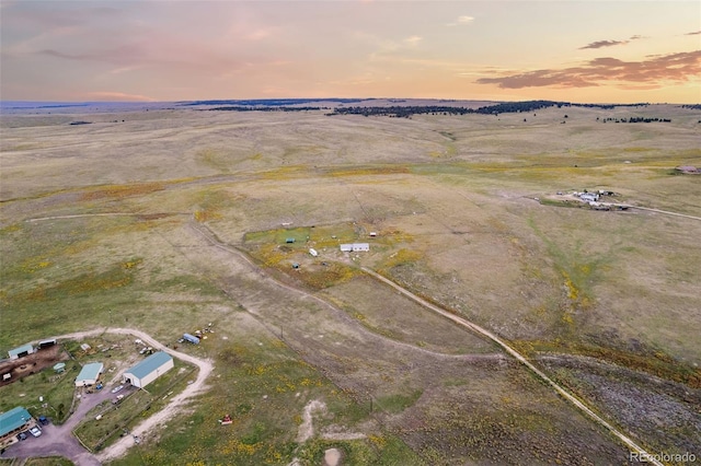 aerial view at dusk featuring a rural view