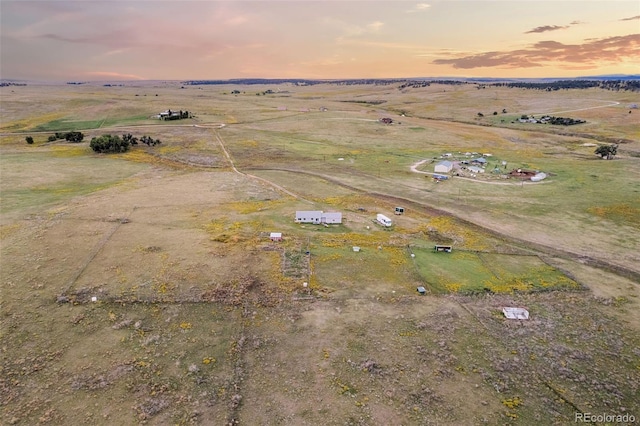 birds eye view of property with a rural view