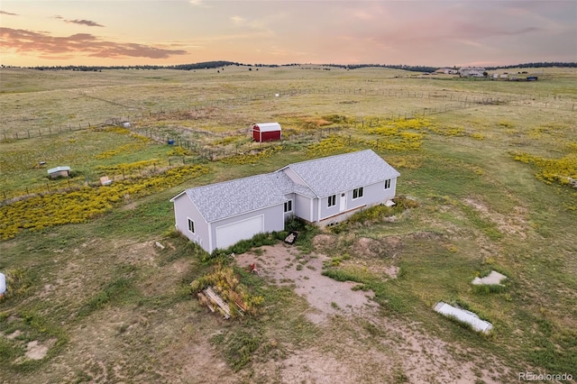 birds eye view of property with a rural view