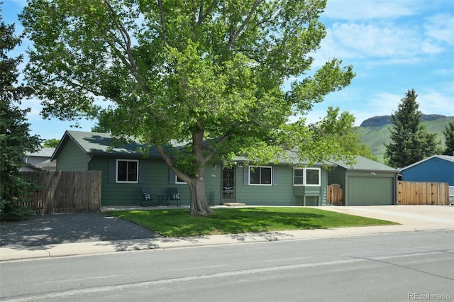 5986 Dunraven St, Golden, CO 80403 - single story home featuring concrete driveway, a garage, and a mountain view