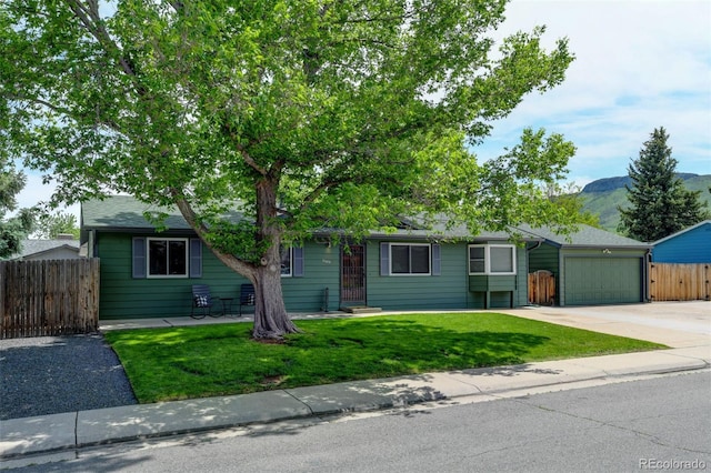 5986 Dunraven St, Golden, CO 80403 - ranch-style house with concrete driveway, an attached garage, and a mountain view