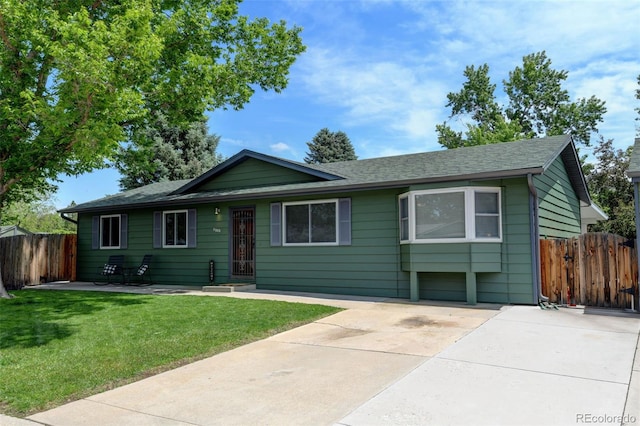 5986 Dunraven St, Golden, CO 80403 - ranch-style home with a shingled roof and concrete driveway
