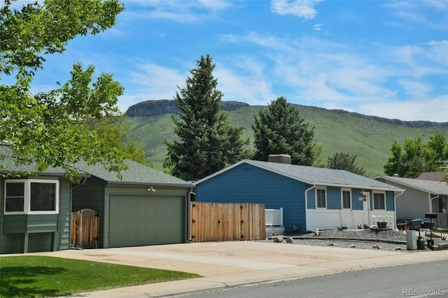 5986 Dunraven St, Golden, CO 80403 - single story home featuring a mountain view, driveway, a garage, a gate, and a chimney