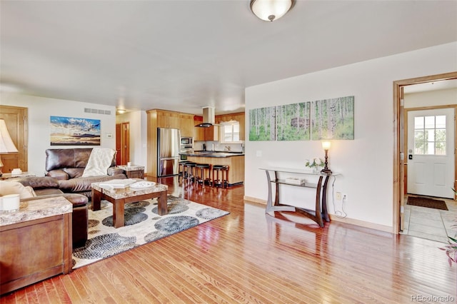 5986 Dunraven St, Golden, CO 80403 - living room featuring light wood-style floors and baseboards