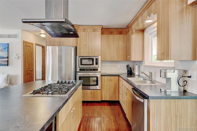 5986 Dunraven St, Golden, CO 80403 - kitchen featuring appliances with stainless steel finishes, light brown cabinetry, a sink, island exhaust hood, and dark countertops